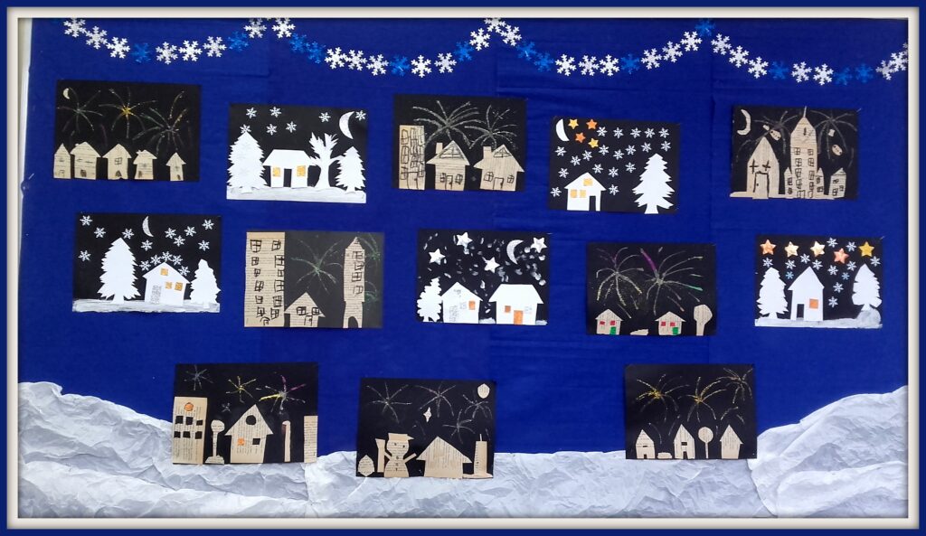 Zimowe obrazki wykonane przez uczniów na tablicy korkowej